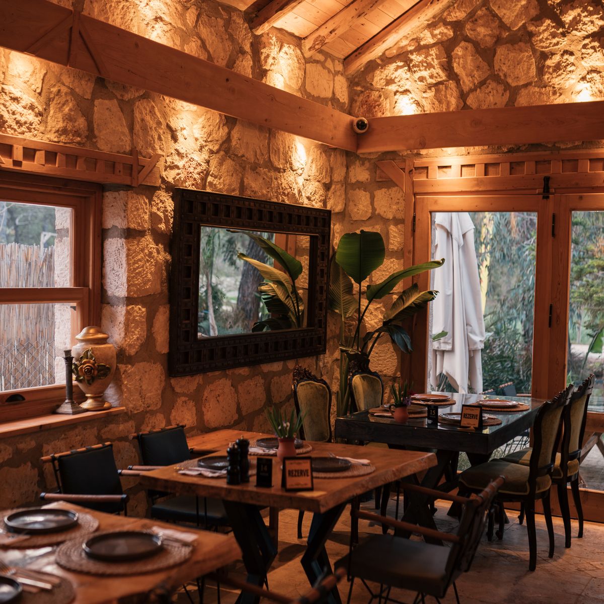 Gedeckter Tisch in der Stube mit Steinwand und warmem Licht